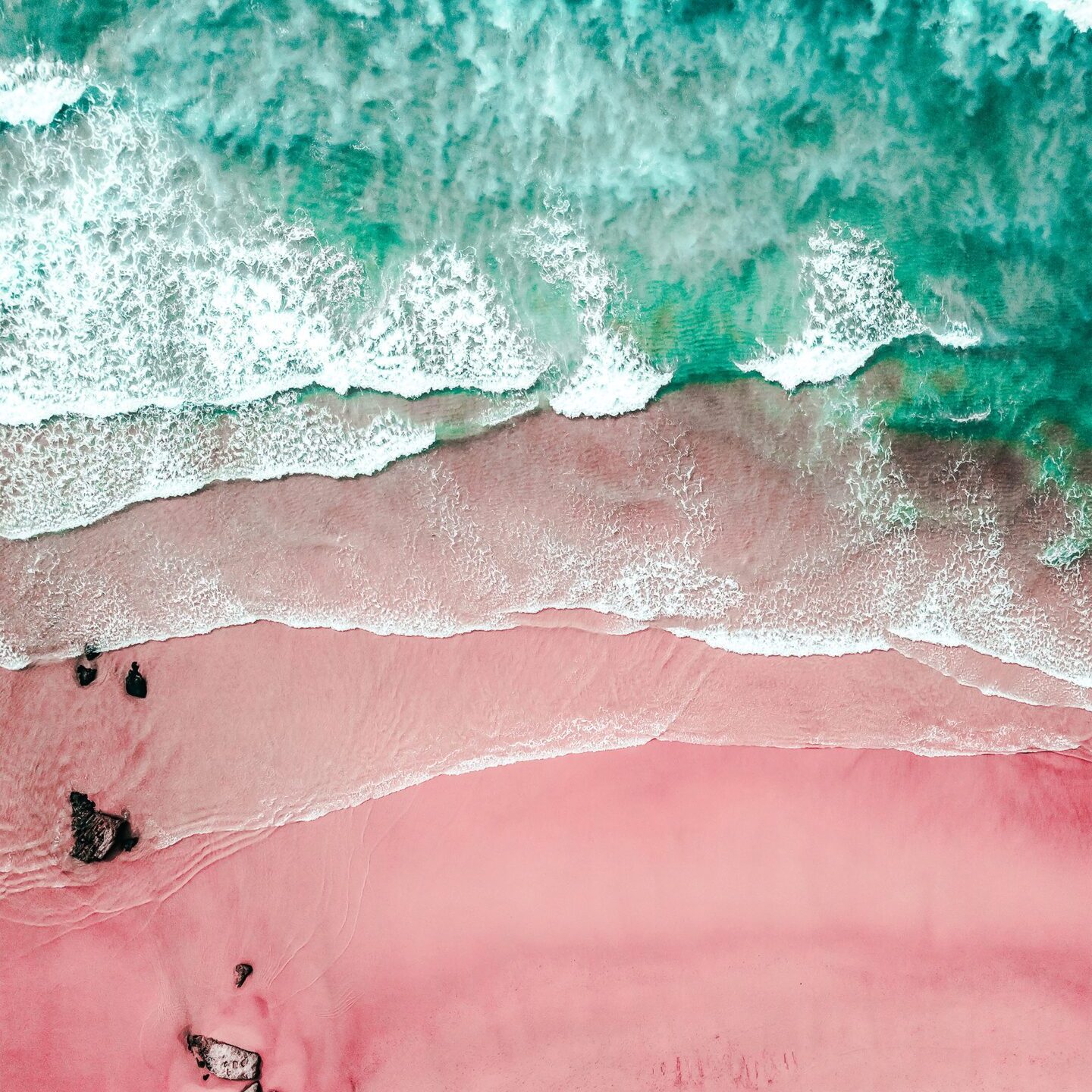 Aerial View Of Ocean Waves And Beautiful Pink Sandy Beach Shore